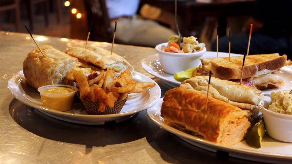 Deli sandwiches and fries served on a plate